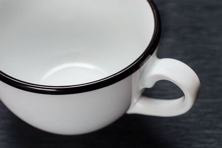 empty white cup with black ends, on a black backgroundの写真素材