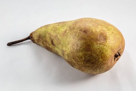 Yellow mature large pear lying on a white backgroundの写真素材