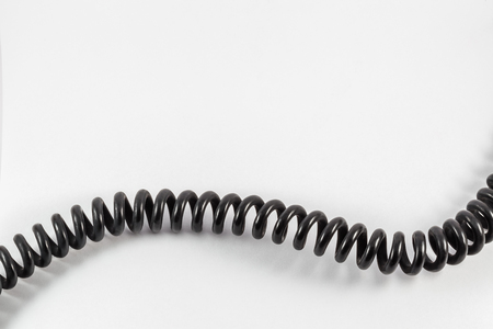black telephone cord on a white backgroundの写真素材
