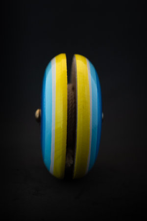 Yo-yo Traditional Mexican wooden handcraft toy, black backgroundの写真素材
