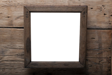 wooden photo frame on old wooden wall