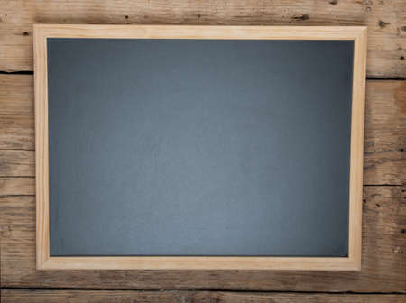 Blackboard on wooden backgroundの写真素材