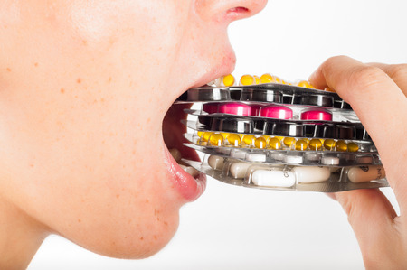 Girl is taking dose of pillsの写真素材