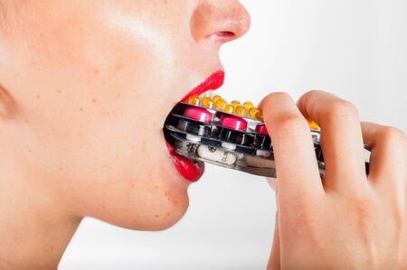 Girl is taking dose of pillsの写真素材