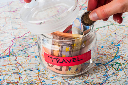 Savings jar for travel on a mapの写真素材