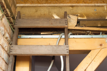 Wooden ladder placed to attic hole to be renovated