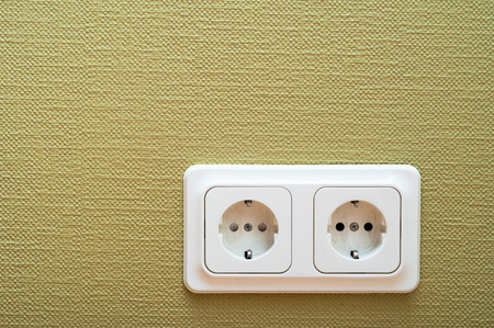 White dual socket on green wallの写真素材