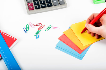 office, school, business, education and technology concept - close up of notebook, paper stickers,...