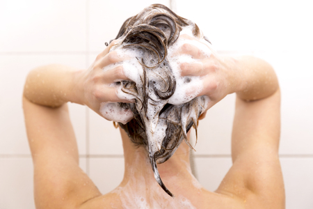 Woman washing her hair in showerの写真素材
