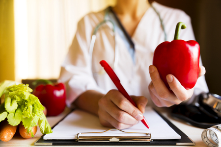 Vegetable diet nutrition and medication concept. Nutritionist offers healthy vegetables diet.の写真素材