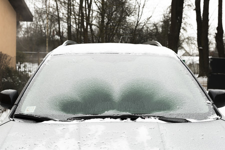 Defrosting ice from car windshieldの写真素材