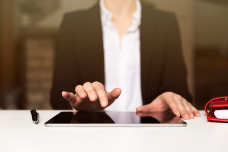 Business woman working on tablet in office