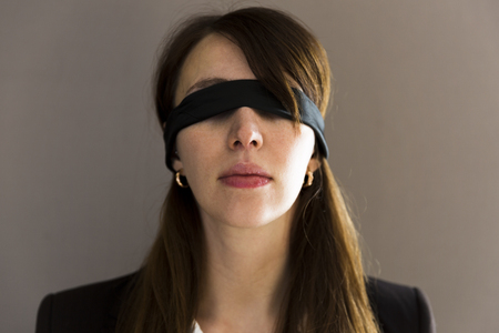 Blind young businesswoman on grey backgroundの写真素材