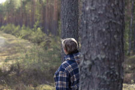 Senior woman walking and relaxing in the forest on a early spring morningの写真素材