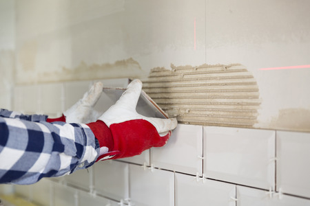 Process of tiling the tiles in the kitchen. Home improvement, renovation conceptの写真素材