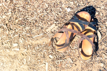Women's summer sandals laying on the beach. Summer vacation concept
