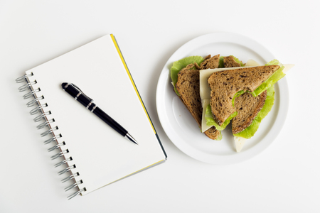 Sandwich from fresh toast with cheese and salad on work place. Work lunchの写真素材