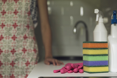 Kitchen cleaning tools. Woman cleaning the kitchen Household equipment, spring-cleaning, tidying up, cleaning service concept.の写真素材