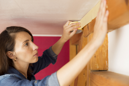 Home improvement. Women taping paint adhesive tapeの写真素材