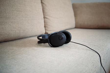 Headphones on a sofa in a living room.の写真素材