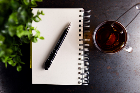 Notebook with a pencil on a rusty metal backgroundの写真素材