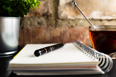 Notebook with a pencil on a rusty metal backgroundの写真素材