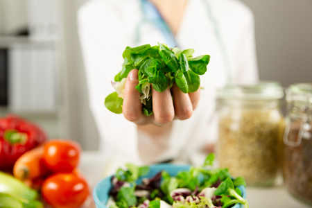 Vegetable diet nutrition and medication concept. Nutritionist offers healthy vegetables diet.の写真素材