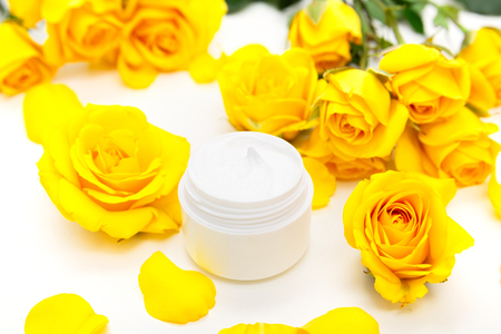 Aromatic botanical cosmetics. Skincare home spa treatment with yellow petals, rose blossom, natural face creamの写真素材