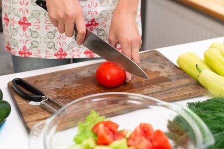 Woman preparing delicious and healthy food in the home kitchen. Healthy diet conceptの写真素材