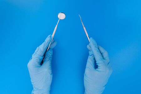 Dentist in medical gloves working with professional stomatology tools . Dental hygiene and health conceptの写真素材