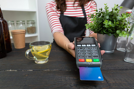 Customer making wireless or contactless payment using credit card