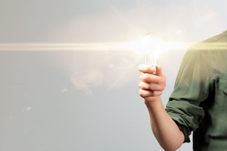 Business woman hand holding lightbulb in office. Concept saving energy, idean and creativity