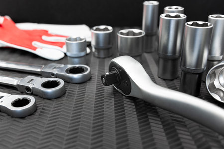 Car repair tools, wrench tool set on a black texture background