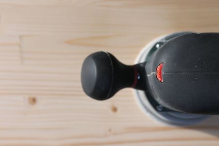Carpentry. Wood sanding. Orbital sander for woodworking. In a natural lightの写真素材