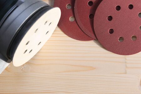 Carpentry. Wood sanding. Orbital sander for woodworking. In a natural lightの写真素材