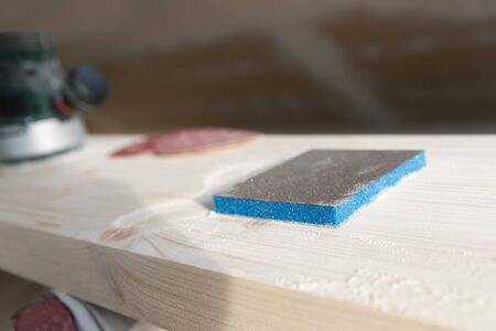 Carpentry. Wood sanding. Orbital sander for woodworking. In a natural lightの写真素材