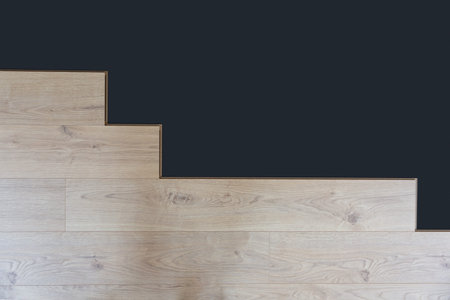 Construction worker installing laminate floor in a new renovated attic. Home improvement concept.の写真素材