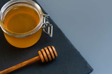 organic honey and rustic bread on a old wooden table. Healthy eating breakfast.の写真素材