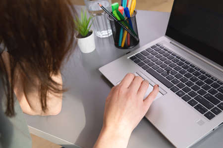 Top view of women browsing in internet by using a mouse pad. Working from home a new normal working concept.の写真素材