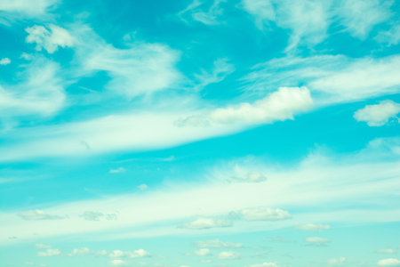 Bright blue sky with moving white clouds. Background
