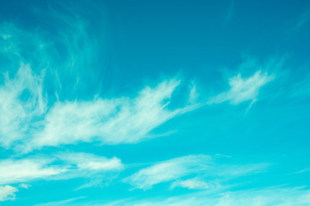 Bright blue sky with moving white clouds. Background
