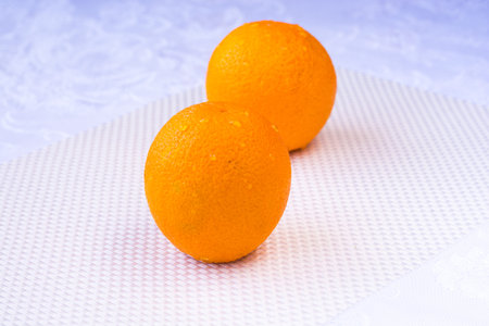 Fresh yellow oranges on a white backgroundの写真素材