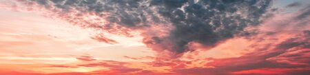 Sky at sunset with dark clouds, panoramic large shot.の写真素材