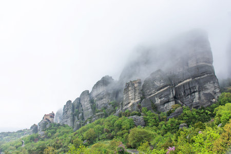 Meteora mountains in Greece during rain, cloudy skyの写真素材