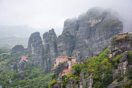 Meteora in Greece, monastery on the background of mountains, cloudy sky