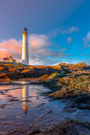 Lighthouse on the coast of the North Sea in Scotland against a dramatic skyの写真素材