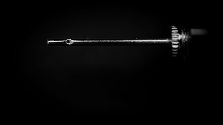 Needle mounted on a ball pump suspended in spaceの写真素材