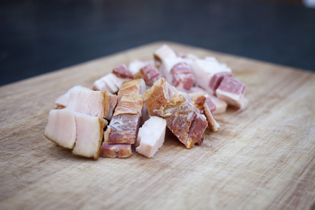 Fresh bacon on the wooden chopping boardの写真素材