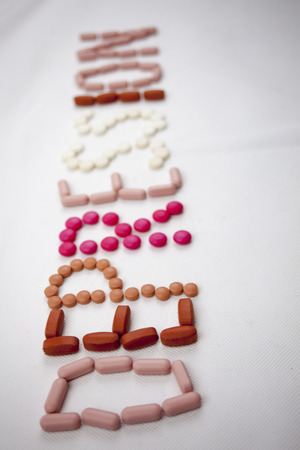 A depression word, writing on the white background on pills with copy space.の写真素材