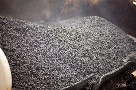 A roadworks on the street new asphalt with workers, Road Roller Road Construction Machinery.の写真素材